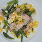 Dish with asparagus chopped boiled eggs and sliced ham