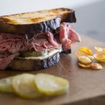 Roast beef sandwich with caramelized onions, pickles and cucumber aioli